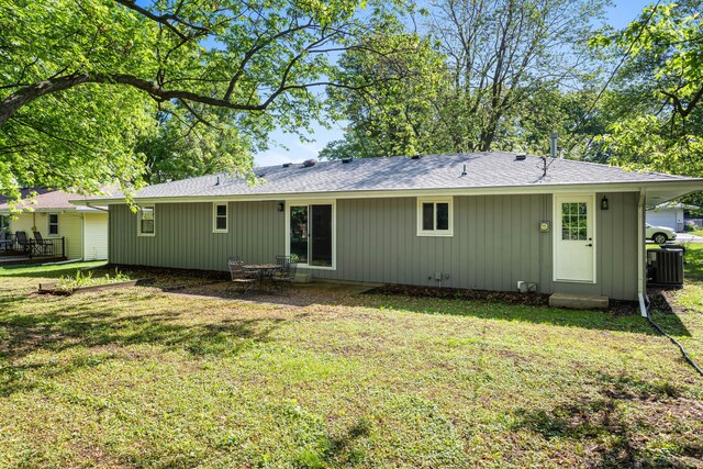 2705 Arlene Dr, Urbana, IL 61802 - rear view of house with a lawn, central AC, and board and batten siding