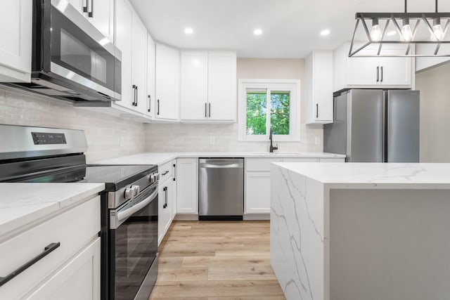 2705 Arlene Dr, Urbana, IL 61802 - kitchen featuring stainless steel appliances, light wood-type flooring, a sink, white cabinetry, and recessed lighting