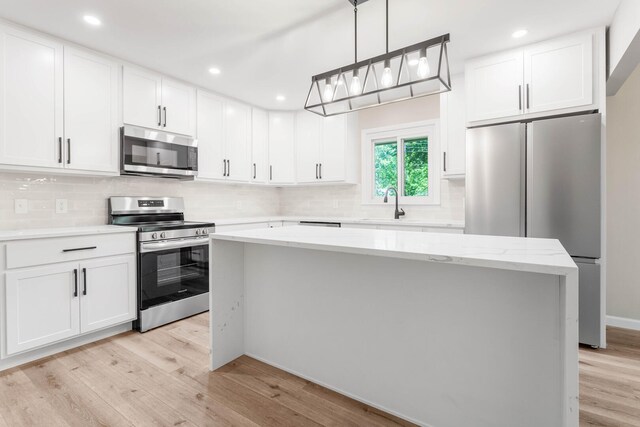 2705 Arlene Dr, Urbana, IL 61802 - kitchen with appliances with stainless steel finishes, light wood finished floors, tasteful backsplash, white cabinets, and recessed lighting