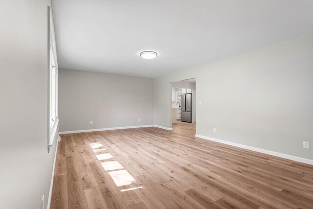2705 Arlene Dr, Urbana, IL 61802 - spare room featuring light wood-style floors and baseboards