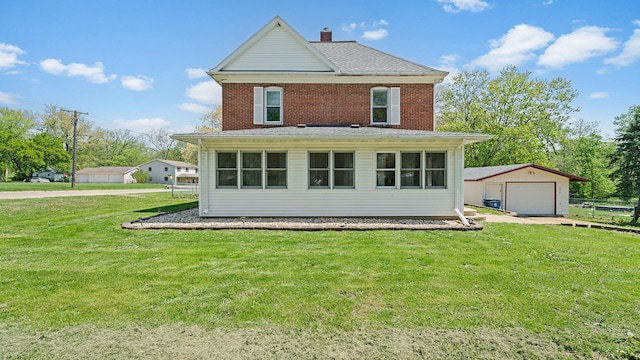 630 Willett Ave, Dixon, IL 61021 - back of house featuring a detached garage, an outdoor structure, a lawn, and brick siding