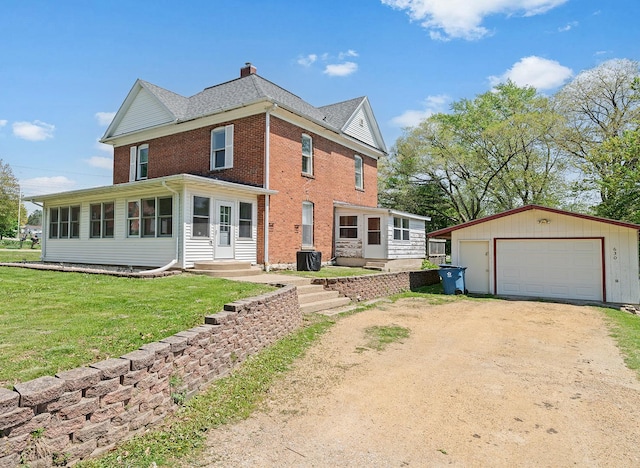 630 Willett Ave, Dixon, IL 61021 - rear view of property featuring dirt driveway, a garage, an outdoor structure, a chimney, and brick siding