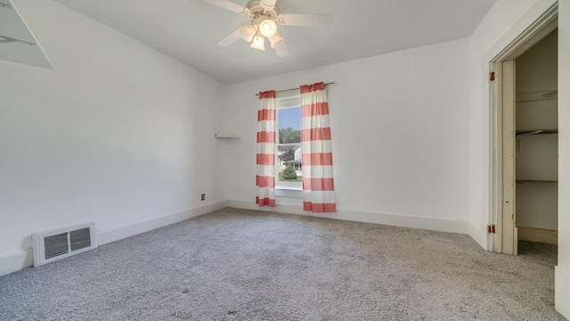 630 Willett Ave, Dixon, IL 61021 - unfurnished bedroom featuring carpet floors, baseboards, a spacious closet, and ceiling fan