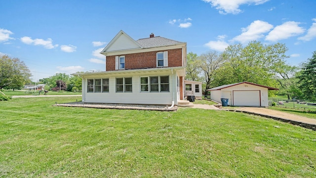 630 Willett Ave, Dixon, IL 61021 - back of house featuring a garage, driveway, an outdoor structure, a yard, and a chimney