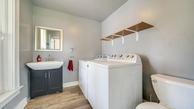 630 Willett Ave, Dixon, IL 61021 - washroom with separate washer and dryer, light wood-style flooring, and baseboards
