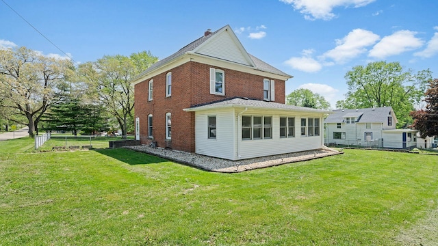 630 Willett Ave, Dixon, IL 61021 - back of house featuring brick siding and a chimney
