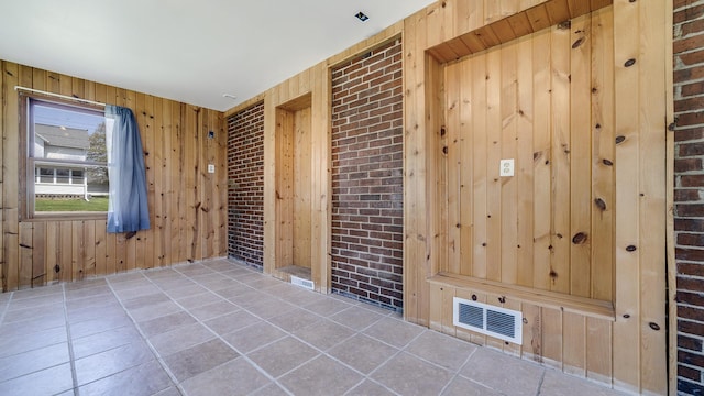630 Willett Ave, Dixon, IL 61021 - unfurnished room with wood walls and tile patterned floors