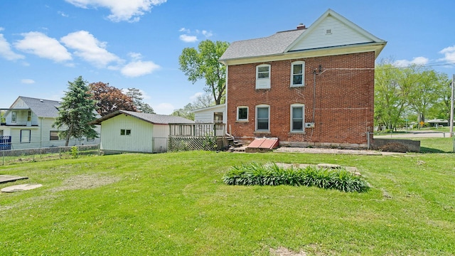 630 Willett Ave, Dixon, IL 61021 - rear view of property featuring a deck, brick siding, and a chimney