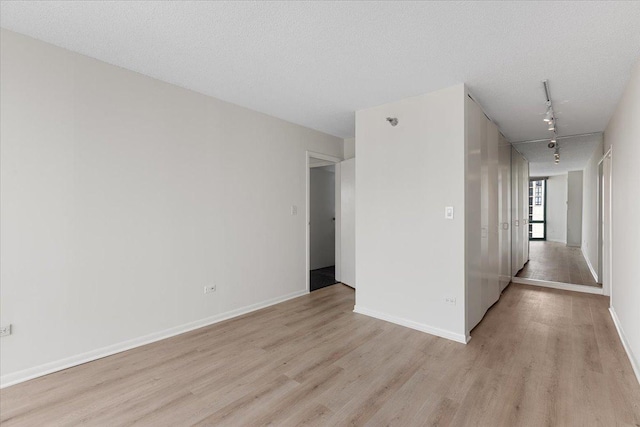 111 W Maple St Unit 3001, Chicago, IL 60610 - unfurnished room featuring light wood-type flooring, baseboards, and track lighting