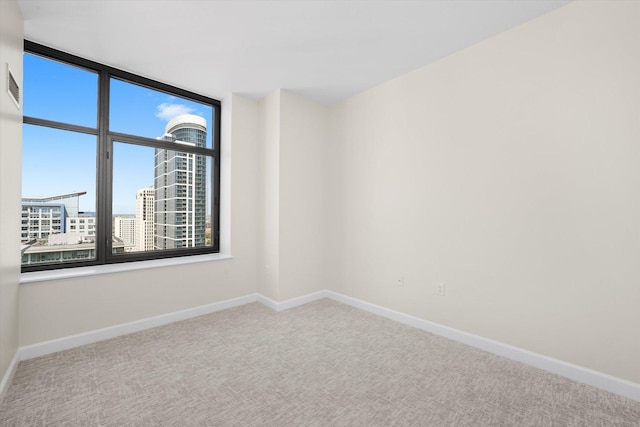 233 E 13th St Unit 2209, Chicago, IL 60605 - spare room with carpet, baseboards, and a city view