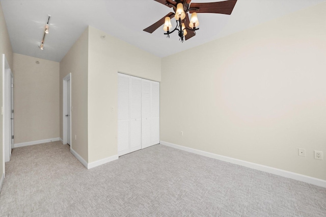 233 E 13th St Unit 2209, Chicago, IL 60605 - unfurnished bedroom featuring a closet, light colored carpet, rail lighting, ceiling fan, and baseboards