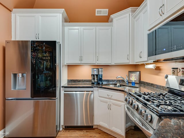 17200 Oak Park Ave Unit R-206, Tinley Park, IL 60477 - kitchen with visible vents, a sink, white cabinetry, dark stone countertops, and appliances with stainless steel finishes