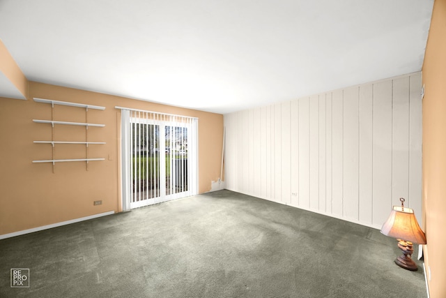 carpeted empty room with baseboards