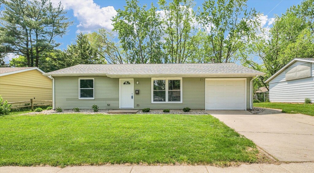 1501 Lincolnwood Dr, Urbana, IL 61802 - ranch-style house featuring driveway, a garage, a front lawn, and roof with shingles