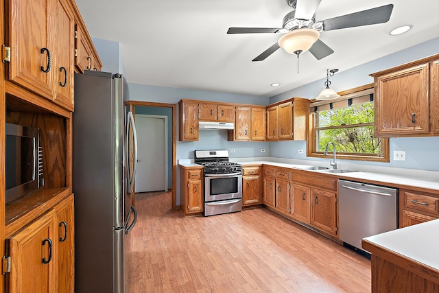 12318 W Donegal Ln, New Lenox, IL 60451 - kitchen featuring appliances with stainless steel finishes, under cabinet range hood, a sink, brown cabinetry, and recessed lighting