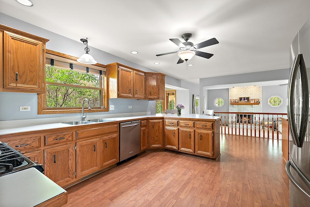 12318 W Donegal Ln, New Lenox, IL 60451 - kitchen with a sink, stainless steel appliances, a peninsula, brown cabinetry, and a ceiling fan