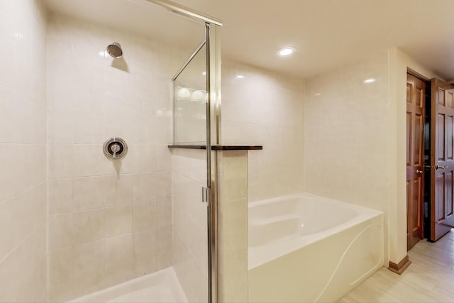 6560 W Diversey Ave Unit 412D, Chicago, IL 60707 - full bathroom featuring a stall shower, a garden tub, and recessed lighting