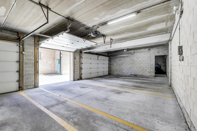 6560 W Diversey Ave Unit 412D, Chicago, IL 60707 - parking deck with a garage door opener and concrete block wall