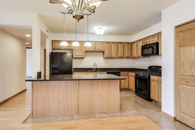 6560 W Diversey Ave Unit 412D, Chicago, IL 60707 - kitchen featuring black appliances, a sink, decorative light fixtures, dark stone counters, and light wood-style flooring