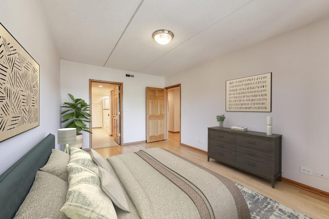 6560 W Diversey Ave Unit 412D, Chicago, IL 60707 - bedroom featuring light wood finished floors, baseboards, and ensuite bath