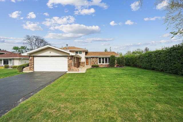 view of front facade featuring a front lawn, a garage, and aphalt driveway