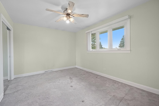 unfurnished bedroom featuring a closet, visible vents, ceiling fan, carpet flooring, and baseboards