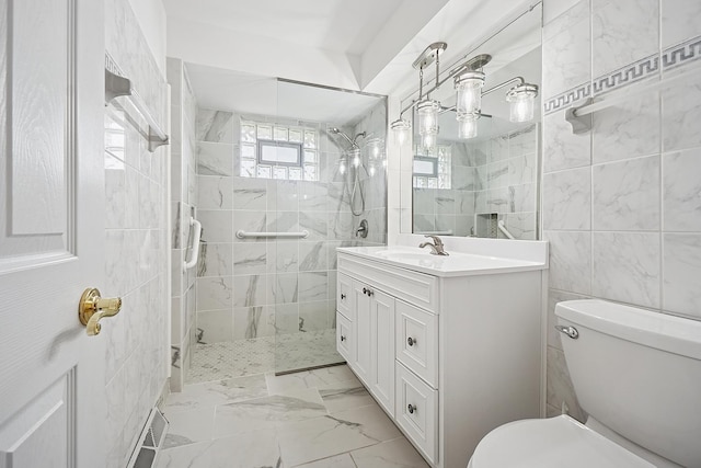 full bath featuring toilet, a walk in shower, tile walls, marble finish floor, and vanity