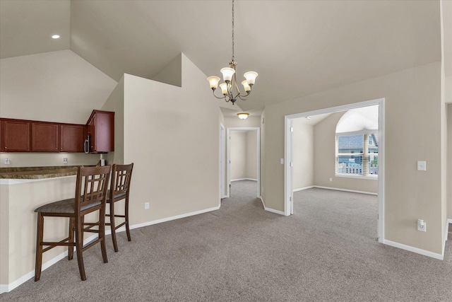 unfurnished dining area featuring light colored carpet, vaulted ceiling, a chandelier, baseboards, and recessed lighting