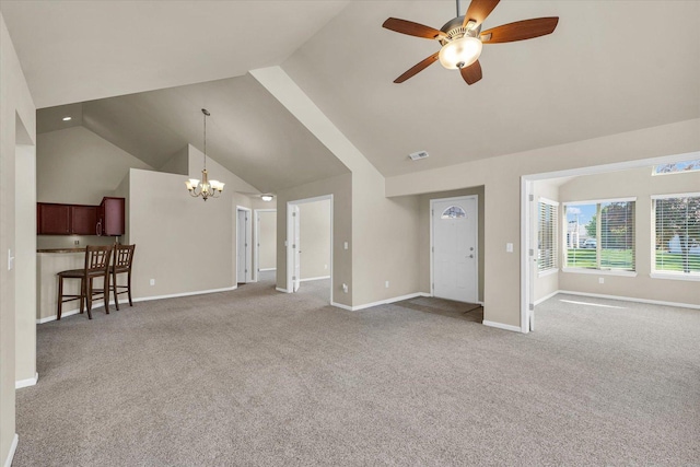 unfurnished living room with a chandelier, high vaulted ceiling, a ceiling fan, carpet flooring, and baseboards