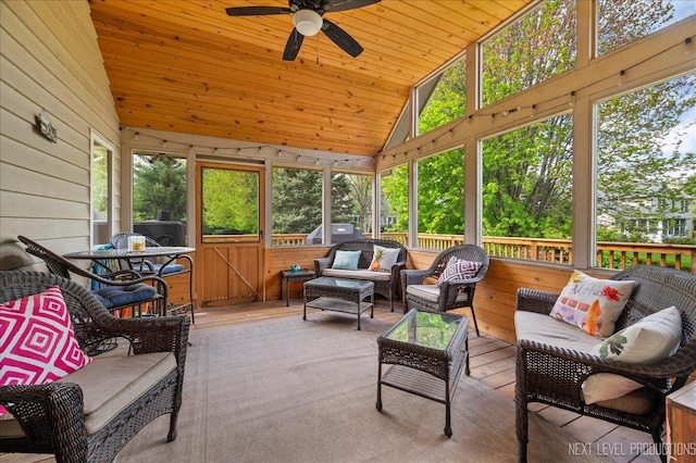 sunroom / solarium with a ceiling fan, lofted ceiling, plenty of natural light, and outdoor lounge area