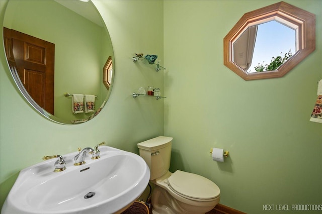 half bathroom with a sink and toilet