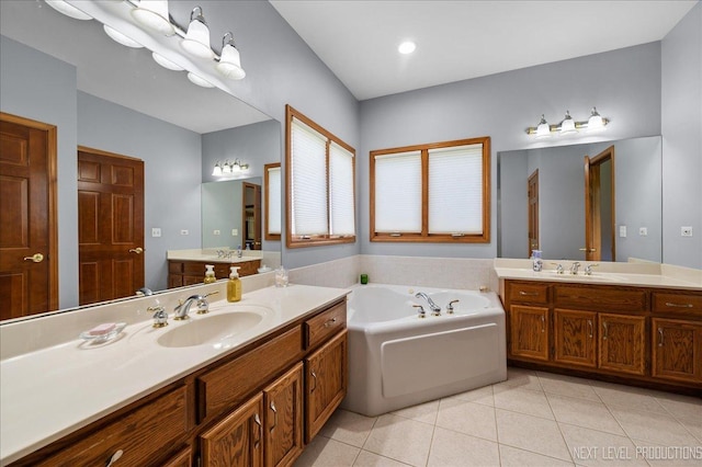 full bathroom featuring tile patterned flooring, a bath, and two vanities