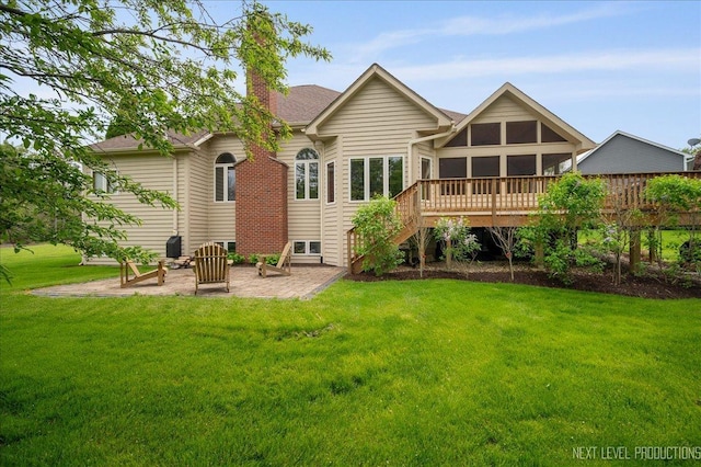 rear view of property with a patio area, a chimney, stairs, a lawn, and a sunroom