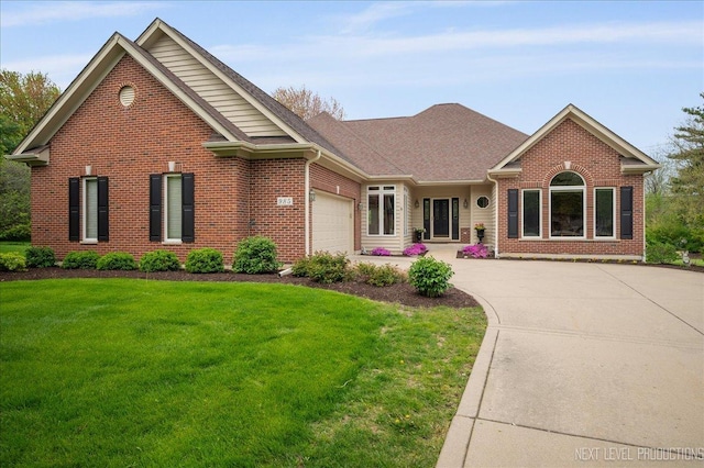 view of front facade featuring brick siding, an attached garage, a front yard, driveway, and roof with shingles