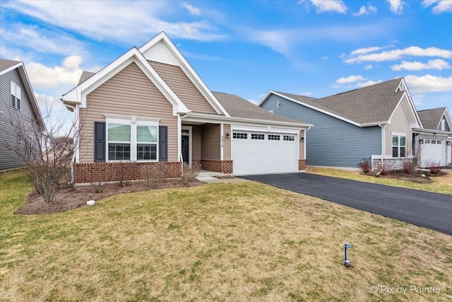 3610 Reddington Cir, Elgin, IL 60124 - ranch-style house with driveway, brick siding, an attached garage, and a front yard