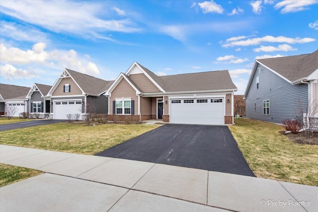 3610 Reddington Cir, Elgin, IL 60124 - view of front of home with driveway, brick siding, a garage, and a front yard