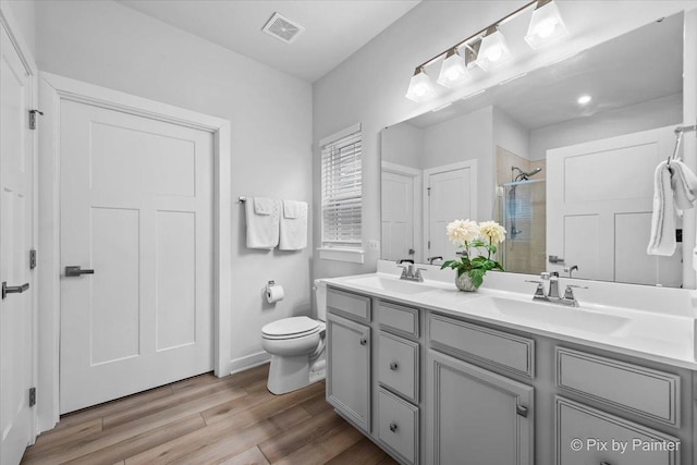 3610 Reddington Cir, Elgin, IL 60124 - bathroom featuring visible vents, wood finished floors, a shower stall, and a sink