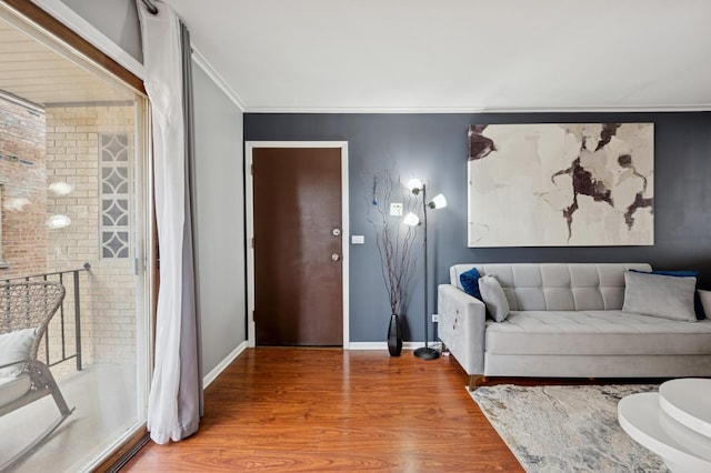 6259 N NW Hwy Unit 3D, Chicago, IL 60631 - living room featuring an accent wall, ornamental molding, baseboards, and wood finished floors