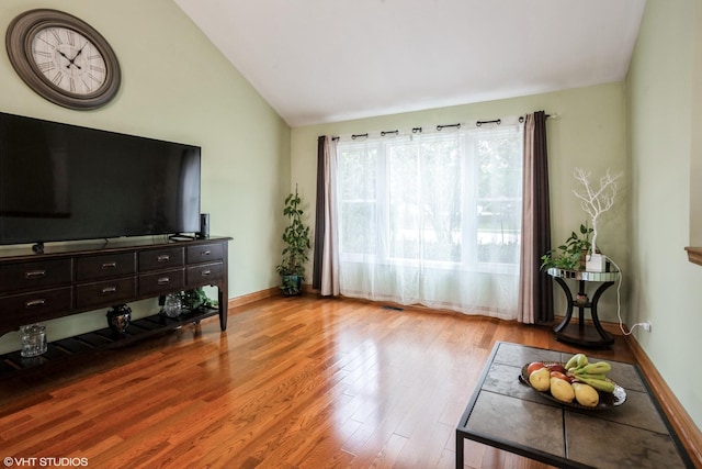 1319 President St, Glendale Heights, IL 60139 - living area with baseboards, wood finished floors, and lofted ceiling