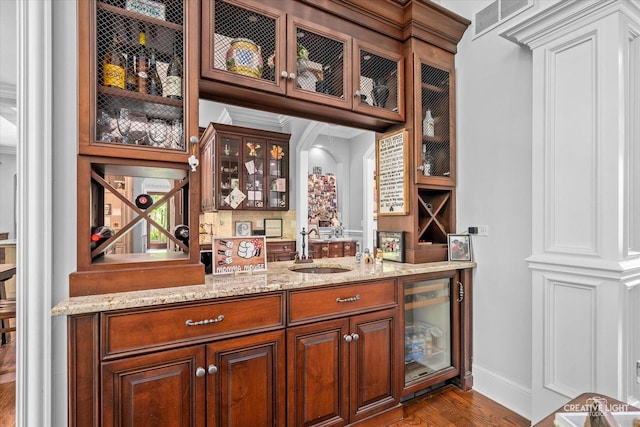 4779 Lees Ct, Oswego, IL 60543 - indoor bar with beverage cooler, dark wood-style flooring, baseboards, and decorative backsplash