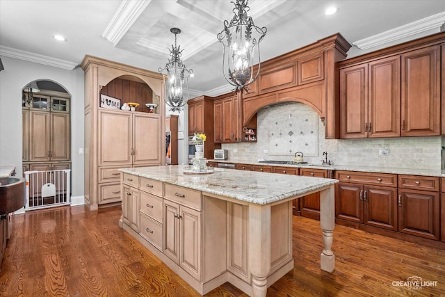 4779 Lees Ct, Oswego, IL 60543 - kitchen featuring arched walkways, dark wood finished floors, a center island, ornamental molding, and recessed lighting