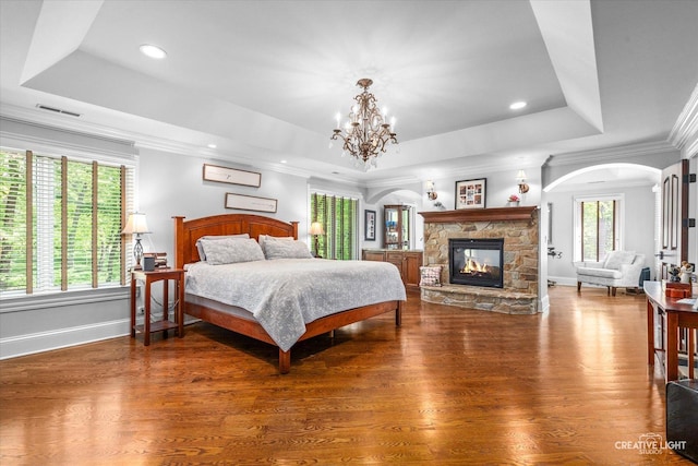 4779 Lees Ct, Oswego, IL 60543 - bedroom with a raised ceiling, a fireplace, a chandelier, baseboards, and recessed lighting