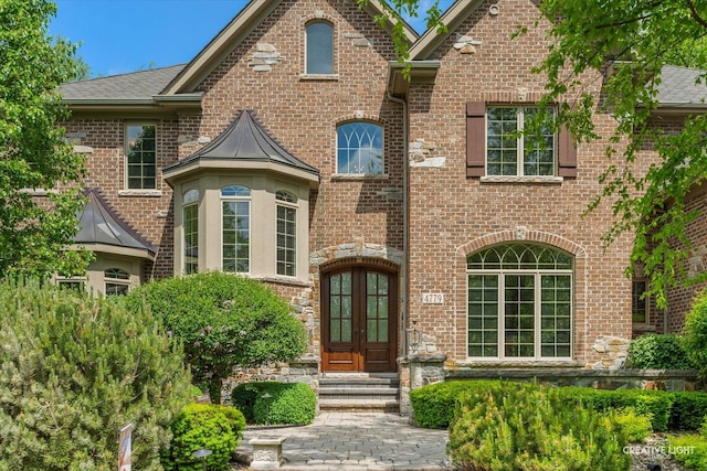 4779 Lees Ct, Oswego, IL 60543 - view of front of house featuring french doors, brick siding, and a shingled roof