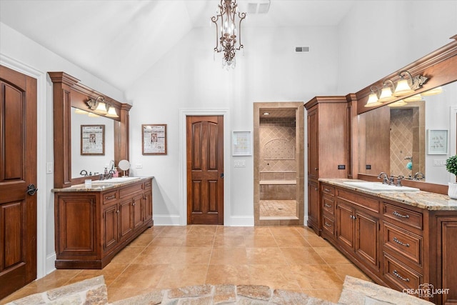 4779 Lees Ct, Oswego, IL 60543 - full bath with high vaulted ceiling, two vanities, a walk in shower, and baseboards