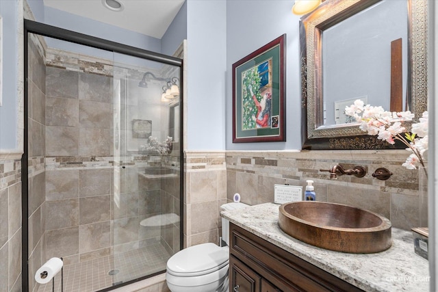 4779 Lees Ct, Oswego, IL 60543 - full bathroom with tile walls, a shower stall, toilet, vanity, and wainscoting