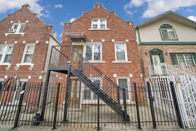 2720 S Christiana Ave, Chicago, IL 60623 - townhome / multi-family property with a fenced front yard, brick siding, and stairway