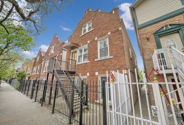 2720 S Christiana Ave, Chicago, IL 60623 - view of side of home featuring stairs, a residential view, brick siding, and fence private yard