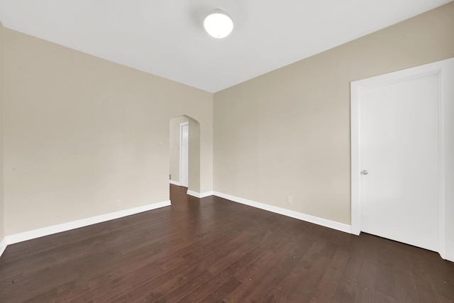 2720 S Christiana Ave, Chicago, IL 60623 - spare room with arched walkways, baseboards, and dark wood finished floors