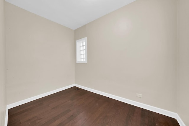 2720 S Christiana Ave, Chicago, IL 60623 - unfurnished room with baseboards, visible vents, and dark wood-type flooring