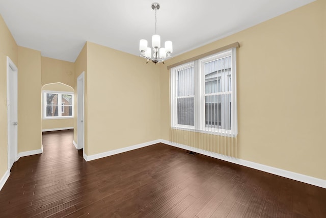 2720 S Christiana Ave, Chicago, IL 60623 - spare room with baseboards, dark wood finished floors, a chandelier, and visible vents